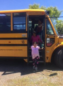 A girl getting of the bus at Ephphatha Farm